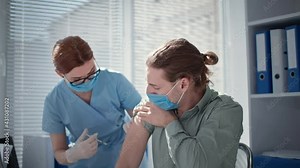 female doctor injections of vaccine with syringe and needle against covid in medical office
