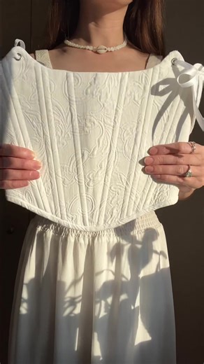 A vision of conscious elegance. Luna Corset is handmade from thrifted textiles, giving new life to once-forgotten fabrics. Its sculpted silhouette flatters with soft structure — delicately boned for gentle support and finished with brass grommets and satin ribbon lacing.#corsets #whitecorset #womenfashion #handmade #slowfashion