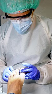 Female podiatrist doing chiropody in her podiatry clinic. Selective focus
