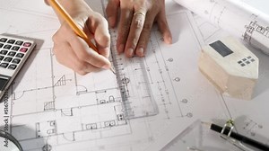 Architectural project workspace. Top view of architect drawing with ruler on house plan blueprint paper for repair tools on table desk at architecture office, architect sketching construction project