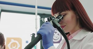 Surgeon Looking Into Microscope Female Patient Stock Footage Video (100% Royalty-free) 1067181235 | Shutterstock