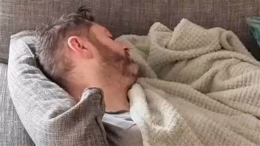 Toddler helps his mom with washing while his dad takes a well-earned nap