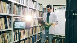 Young teacher is holding an internet lesson in a library