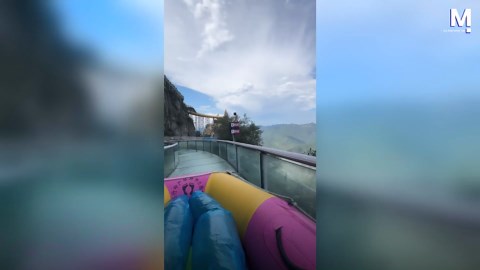 Daredevils only! Tourists race down glass water slide in Chinese mountains