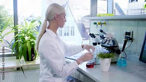 Scientist working in lab. Female doctor making medical research. Laboratory tools: microscope, test tubes, equipment. Biotechnology, chemistry, science, experiments and healthcare concept.