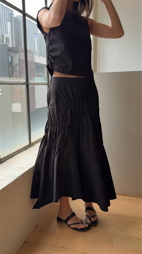 The Raven Skirt worn by Sunny. Sculptural ease in classic black — one of our most-loved styles. | Alpha60
