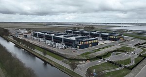 Aerial drone view of a large datacenter under construction, internet infrastructure building at Agriport, The Netherlands. Computing and internet data structure. Birds eye view.