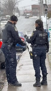 How a big police look standing next to his partner