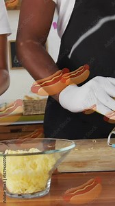 Preparing hot dogs with grated cheese, hot dog animation over kitchen scene