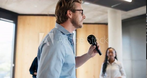 Advice, inspiration and microphone with motivational speaker man in office for life coaching. Business, crowd and speech with person in workplace for employee development, pep talk or support