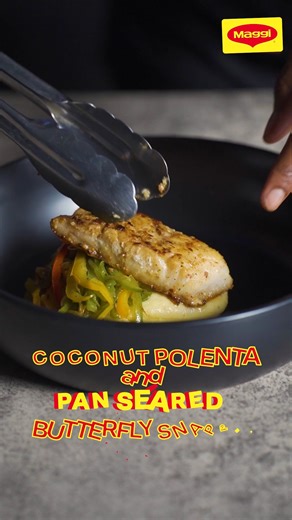 This is what we mean when we say we have dinner at home! 🤣 Cook like a pro and try this Pan Seared Snapper and Coconut Polenta recipe at home. Ingredients For Polenta: 1 cup cornmeal 2 cups water I cup coconut milk (Maggi coconut milK) 1 tablespoon Maggi all-purpose seasoning Pan-Seared Butterfly Snapper Fillet: 4 snapper fillets, butterfly cut 1 tablespoon Maggi Unique Fish seasoning 2 tablespoons olive oil 1 scotch bonnet pepper, thinly sliced 1 onion, julienned 1 red bell pepper, julienned 1