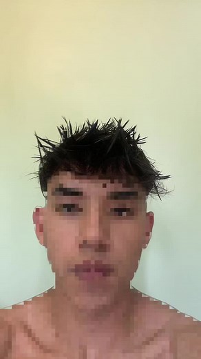 Shirtless Man with Spiky Hair in Indoor Setting