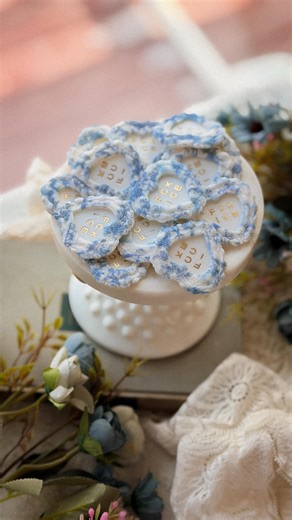 Meg ✿ Polymer Clay Earrings + More on Instagram: "Just a small biz girlie attempting to fight fascism one handmade keychain at a time 🫡🤍🫶🎀 these sweet and demure chinoiserie FCK ICE heart keychains are handmade with polymer clay, by yours truly 😘 they’re actually quite labor intensive (my shoulders are screaming 🥲) and I design and print my own image transfers right in my home studio✨ in addition to keychains, I also have brooches, hat pins, bag charms, magnets, earrings + more in my shop!