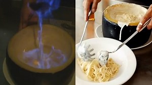 This pasta dish is made in a flaming wheel of gooey cheese. | Insider Food