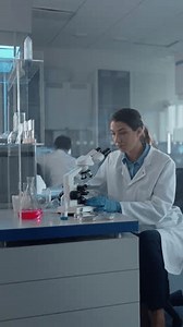 Vertical Video. Medical Science Laboratory with Diverse Team of Biochemistry Scientists Developing Drugs, Medicine, Biotechnology Research. Working on the Computer, Using Microscope, Analyzing Samples