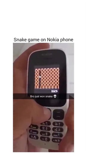 @gearheadgiggle on Instagram: "The video captures a person playing a classic snake game on a Nokia feature phone. At 00:22, a single word—“Isso”—is spoken, likely an exclamation or affirmation related to the gameplay. The screen displays the snake navigating a grid, moving smoothly as it consumes dots to grow longer. The player uses the phone’s keypad to control the snake’s direction, avoiding collisions with the grid boundaries and its own body. Throughout the 24-second clip, the snake steadily