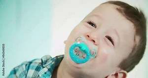 Little toddler in pyjamas crying and standing in his baby bed. Shoot on Digital Cinema Camera in 4K - ProRes 422 codec.