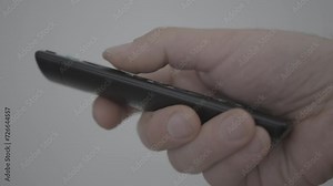 Man uses black remote control of a smart tv. Closeup cinematic 4k shot