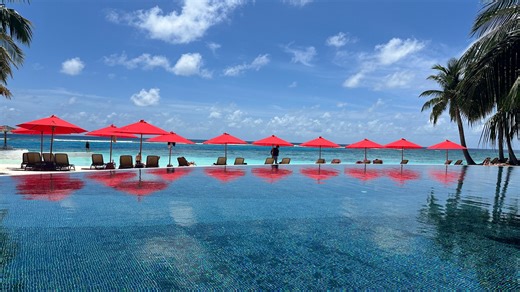 Inside Maldives resort with infinity pool, water swings, live music & boat trips