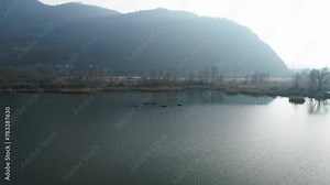 A few docks in the middle of the lake between mountains