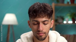 Middle eastern young man with beauty product, applying anti-aging nourishing moisturizing serum. Skin care routine, facial cosmetics