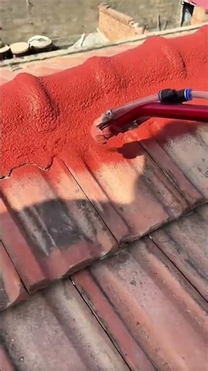 Applying Red Waterproof Roof Coating Using a High Pressure Spray Gun
