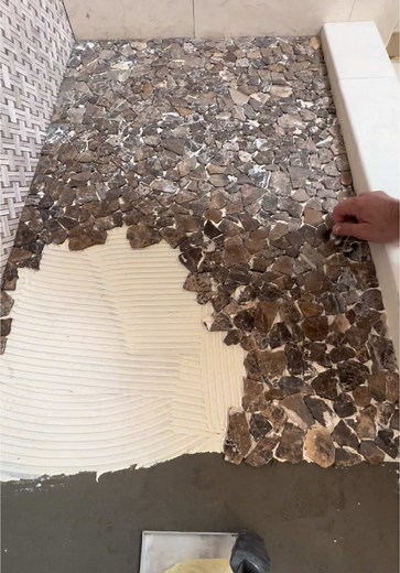Watch as I transform a shower pan with a stunning flat river rock pebble design! To achieve a seamless, natural look, I removed the stones from the manufacturer’s backing and carefully set each one individually. This meticulous process ensures there are no visible grid lines, creating a flawless finish. Perfect for anyone looking for a unique and professional shower upgrade! #ShowerPan #TileDesign #RiverRockPebble #BathroomRenovation #HomeImprovement #CustomTileWork #SeamlessLook #DIYBathroom #T