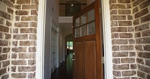 Front Home Entrance Low Angle Door Open Rise Up. rising low angle shot of the front entrance as the door opens to reveal the hallway of a modern residential home