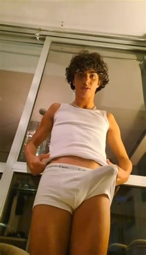Curly haired twink shows off