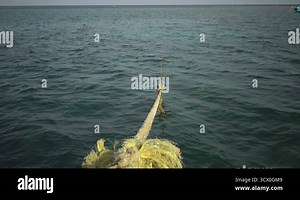 Close-up nautical knot rope tied around stake on boat or ship, boat mooring rope. Marine rope on the ship. The ship leaves the port. Lighthouse.