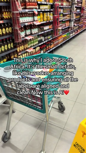 South Africa grocery worker aligns labels perfectly — small detail that impresses