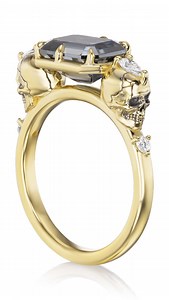 ‘Til death do us part. The Juliet with a dreamy emerald cut grey moissanite, suspended between solid gold skulls. 💀 This ring is in stock and ready to ship for Christmas or New Year’s! Treat yourself, or get someone the most emo (in a good way) gift ever. Each skull is adorned with a pear shaped diamond to create a three-stone look from top view. The shank stones can be customized with birthstones to symbolize the special souls in your life — you and your love, special people or pets, or to mar