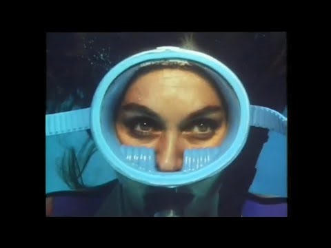 Female Diver is Diving with Neoprene Wetsuit