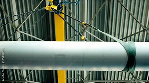 Pipe is lowered on the crane. Enterprise for production of pipes