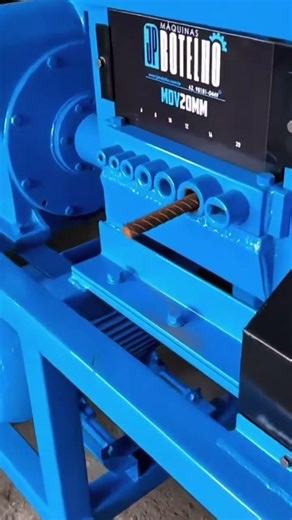 A rusty bent thick iron is placed into this blue tool, making it straight again without any bend.