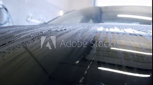 Low angle camera view showing hydrophobicity effect on black car mask