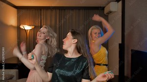 Three laughing girls dancing together in house at party. Happy of friday ending party hard. Only dance and no other. Pleasure and carelessness without thoughts only dance.