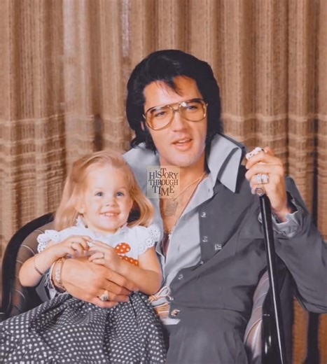 "Elvis Presley and his wife, Priscilla, were photographed in 1970 at their iconic Graceland Mansion in Memphis, Tennessee, alongside their daughter, Lisa Marie Presley, who was then just two years old. Graceland, purchased by Elvis in 1957, had grown into both a family home and a cultural landmark, symbolizing his extraordinary career and lifestyle. By this point, Elvis was deeply immersed in his Las Vegas residencies while also enjoying life as a devoted father. The family portrait at Graceland