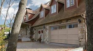Discover the new garage door from Garaga with personality. The Cambridge features the authentic architectural elements of recessed panel doors, with overlays of rich woodgrain finish, without the maintenance of traditional wood. | Garaga