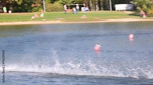Two rapid radio-controlled model boats competing in the lake