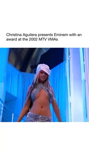 Pop Music on Instagram: "This moment is from the 2002 MTV Video Music Awards, when Christina Aguilera presented Eminem with the award for Best Male Video for “Without Me.” It’s remembered because there was real tension between them at the time. Eminem had mentioned Christina in several songs in ways that sparked a public feud, so putting her on stage to hand him an award was MTV’s intentional way of creating an awkward, dramatic moment. Christina’s entrance is also famous because this was her St