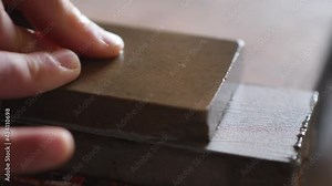 sharpening a chisel on a grinder. professional tool sharpening. carpenter sharpens a chisel before carving wood