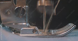 Sewing Denim Jeans On A Sewing Machine. Alteration Jeans, Hemming A Pair Of Jeans, Handmade Garment Industrial Concept. Cinema 4k Video. C4K