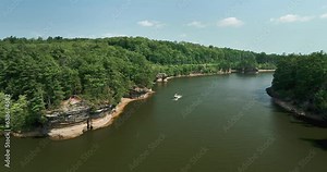 Wisconsin River at Wisconsin Dells with rock formations, aerial along the river with boat on the water