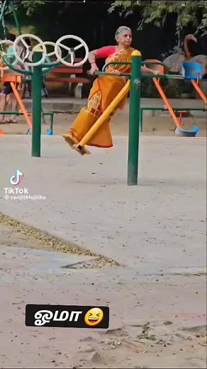 Elderly Woman Joyfully Plays in Playground