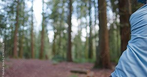 Close up of a man throwing a driver disc while playing disc golf in the Pacific Northwest forest.