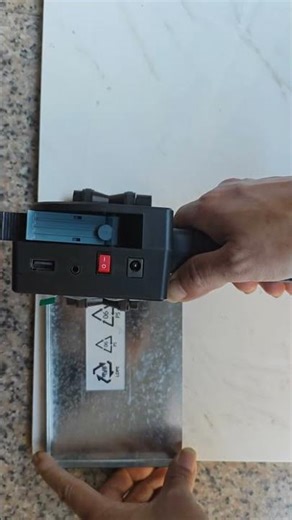 This handheld printer can print on literally ANY material surface - wood, metal, plastic, glass