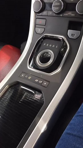 Inserting South African Rand into Car Gear Shift Compartment