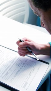 Doctor filling medical insurance form | Premium Stock Video Footage