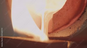 Molten Gold being poured into Ingot moulds. Molten Gold being poured into Ingot moulds. Casting metal or gold being poured into molds in foundry